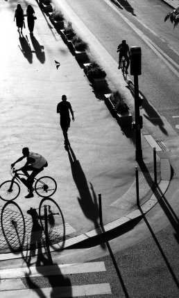 Black and white photography men walking biking shadow Paris street